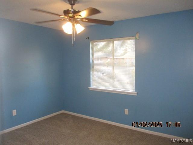 unfurnished room featuring carpet and ceiling fan