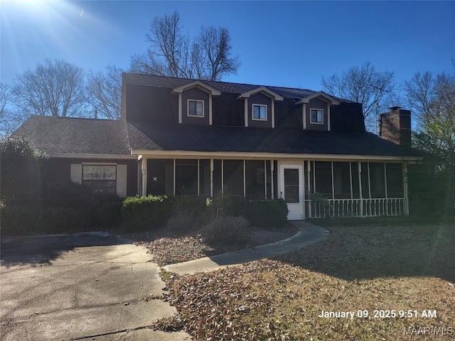 view of front of house featuring a sunroom