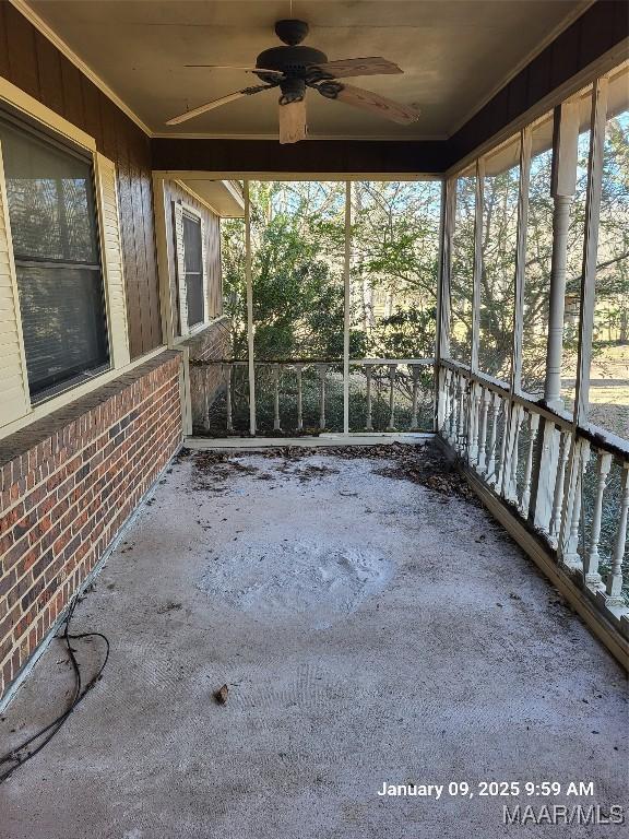 unfurnished sunroom featuring ceiling fan and plenty of natural light