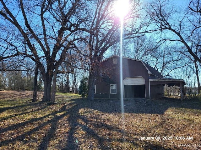 view of side of home with a carport and a detached garage