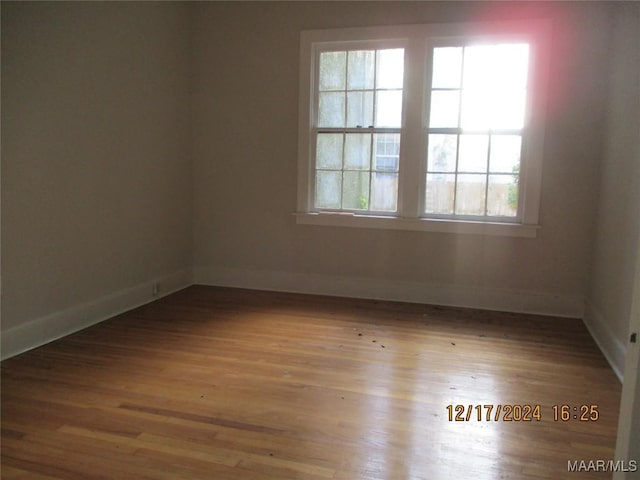 spare room with a wealth of natural light and light hardwood / wood-style flooring