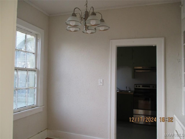 unfurnished dining area with a chandelier, crown molding, and sink