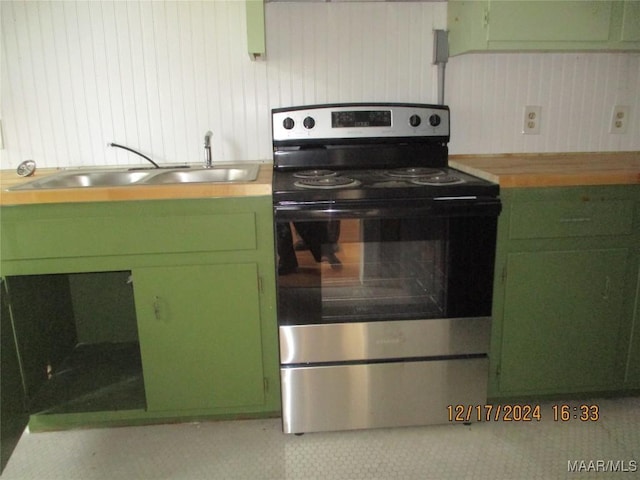 kitchen with electric range, sink, and green cabinetry