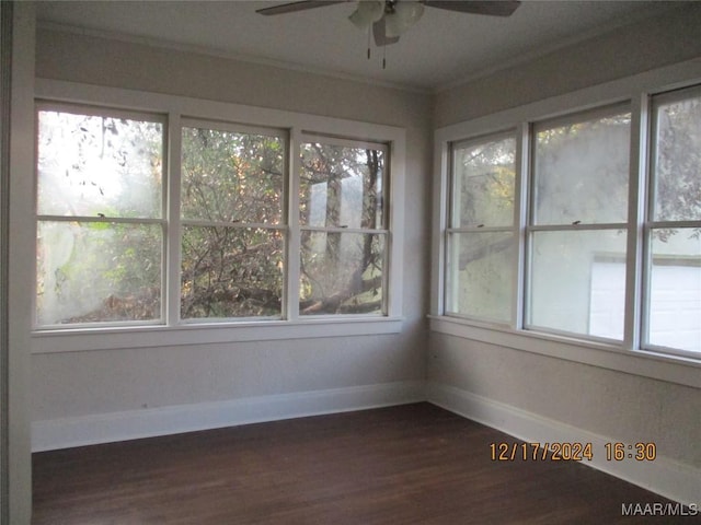 unfurnished sunroom featuring ceiling fan