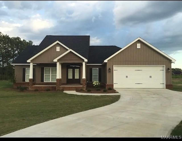 craftsman-style house featuring a front lawn and a garage