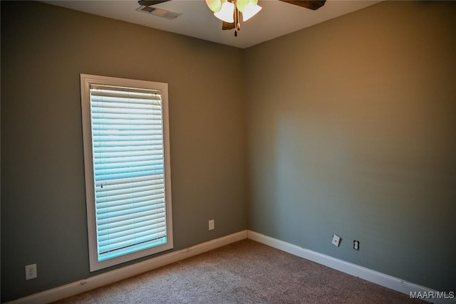 spare room featuring carpet floors and ceiling fan