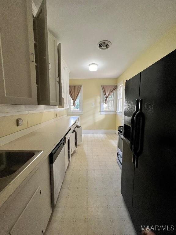 kitchen with white cabinets and appliances with stainless steel finishes