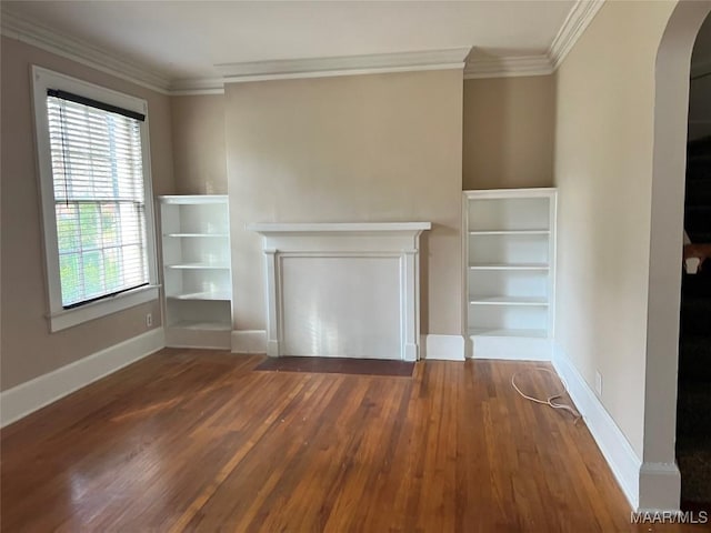 unfurnished living room featuring crown molding, a healthy amount of sunlight, and dark hardwood / wood-style floors