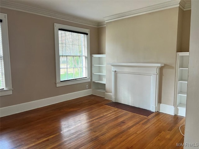 unfurnished living room with ornamental molding, built in shelves, and dark wood-type flooring