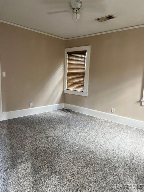 spare room featuring ceiling fan and crown molding