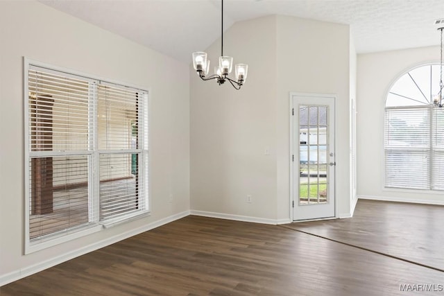 unfurnished dining area with vaulted ceiling, dark hardwood / wood-style floors, and an inviting chandelier