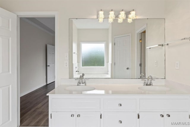 bathroom featuring hardwood / wood-style flooring, vanity, a bathtub, and crown molding