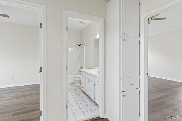 full bathroom featuring vanity,  shower combination, ceiling fan, tile patterned flooring, and toilet