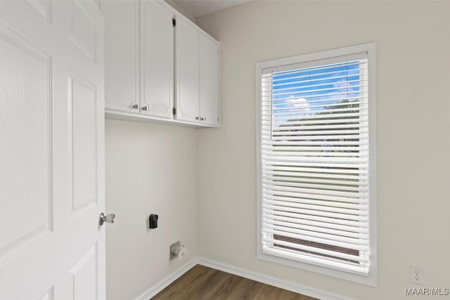 laundry area with cabinets, dark hardwood / wood-style floors, and electric dryer hookup