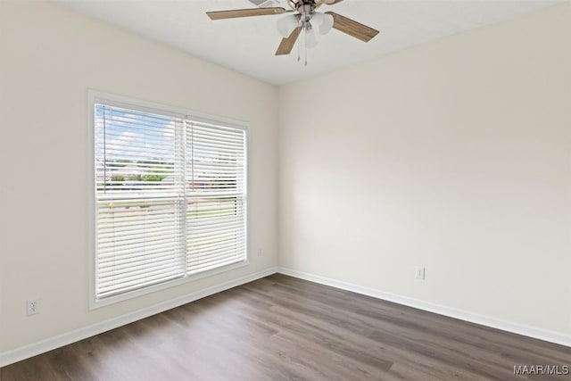 spare room with ceiling fan and dark wood-type flooring