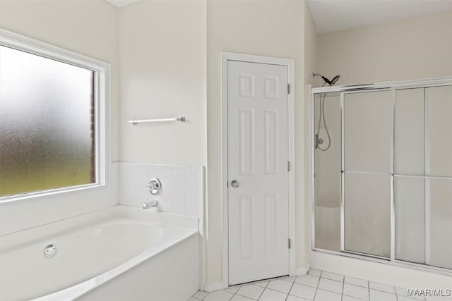 bathroom featuring tile patterned flooring and shower with separate bathtub