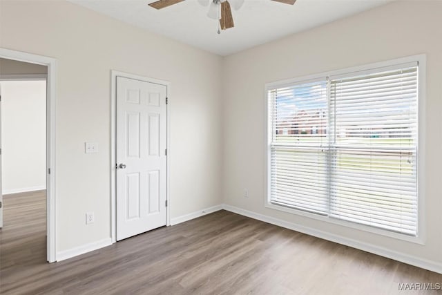 unfurnished bedroom featuring hardwood / wood-style floors and ceiling fan