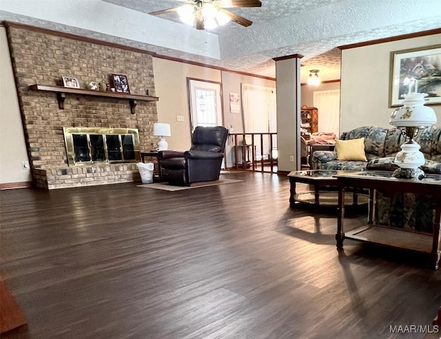 living room featuring a textured ceiling, dark hardwood / wood-style floors, and a brick fireplace