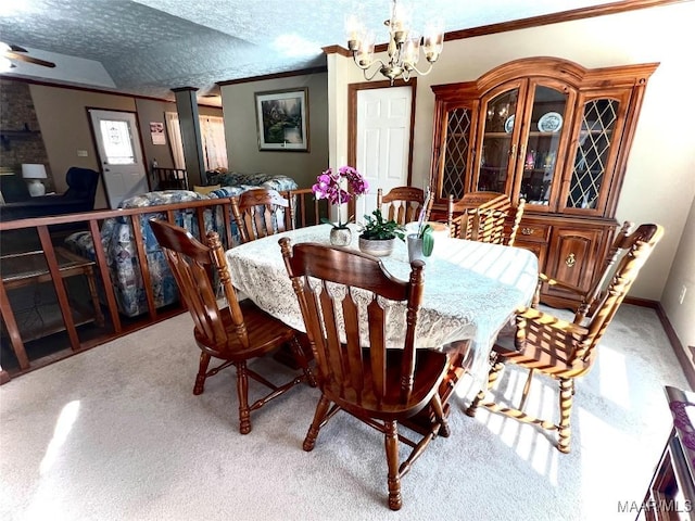 dining area featuring crown molding, a chandelier, a textured ceiling, and light carpet