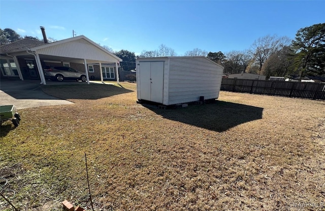 view of yard with a carport and a storage shed