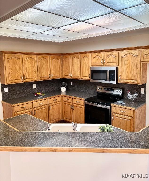 kitchen with tasteful backsplash and appliances with stainless steel finishes