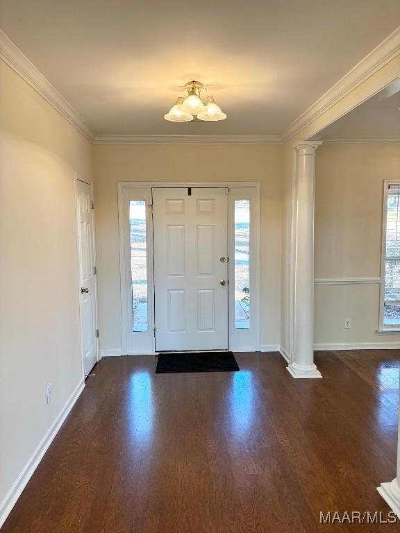 entrance foyer with ornate columns, plenty of natural light, and ornamental molding