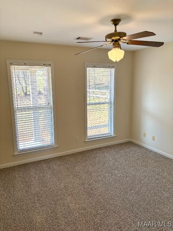 spare room with ceiling fan and carpet floors