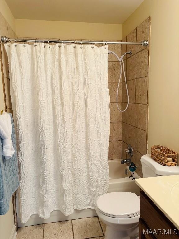 full bathroom featuring tile patterned flooring, shower / bath combination with curtain, vanity, and toilet