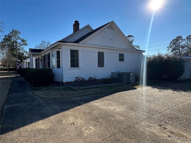 view of side of home with central AC