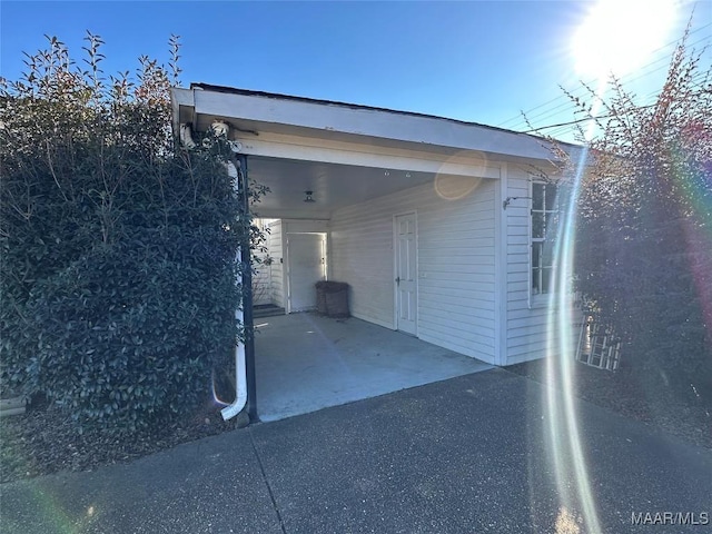 view of side of home with a carport