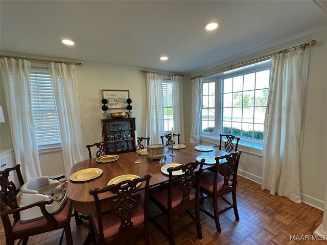 dining room with parquet flooring and ornamental molding