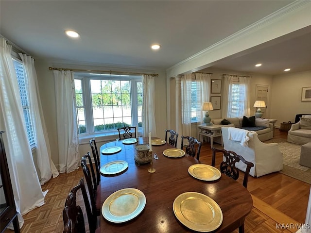 dining area with parquet flooring and crown molding