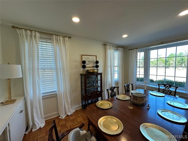 dining room with ornamental molding and parquet flooring