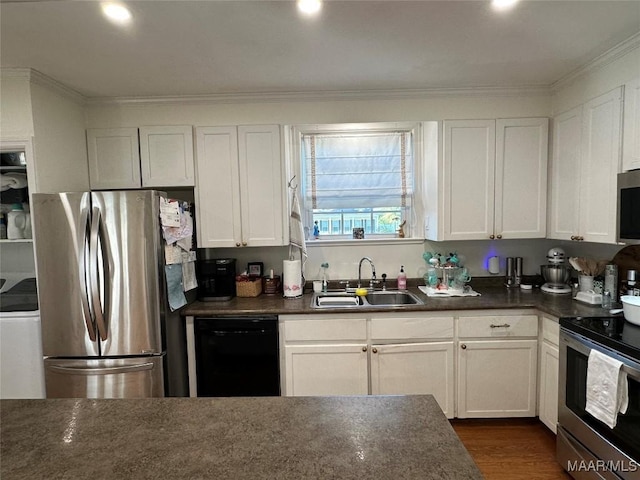 kitchen featuring sink, stainless steel appliances, washer / clothes dryer, white cabinets, and ornamental molding