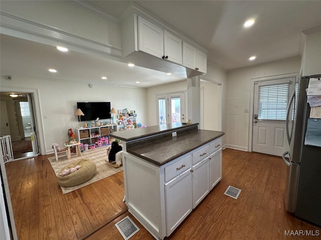 kitchen with stainless steel fridge, dark hardwood / wood-style flooring, white cabinetry, and french doors