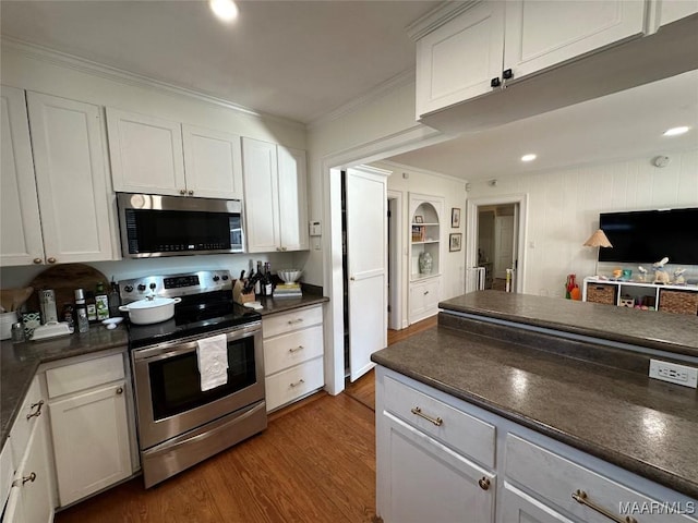 kitchen featuring crown molding, dark hardwood / wood-style flooring, white cabinets, and stainless steel appliances