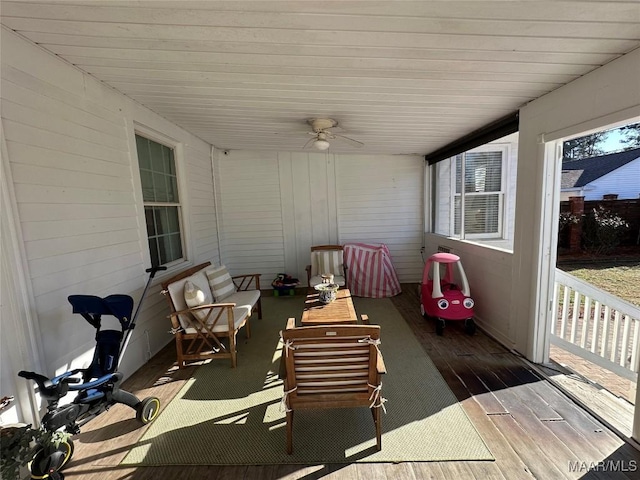 sunroom / solarium featuring ceiling fan