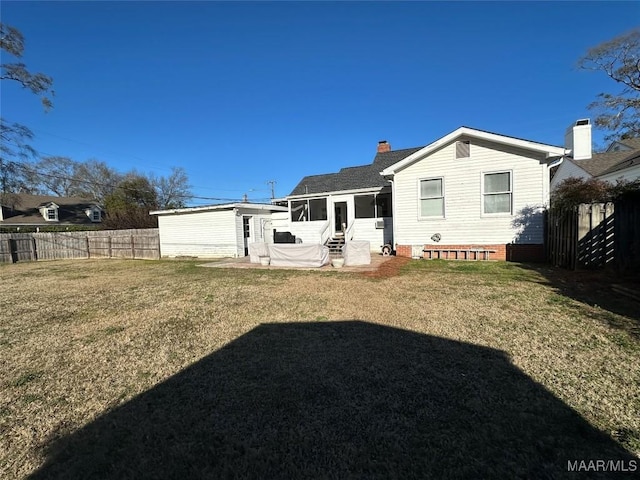 back of property featuring a lawn