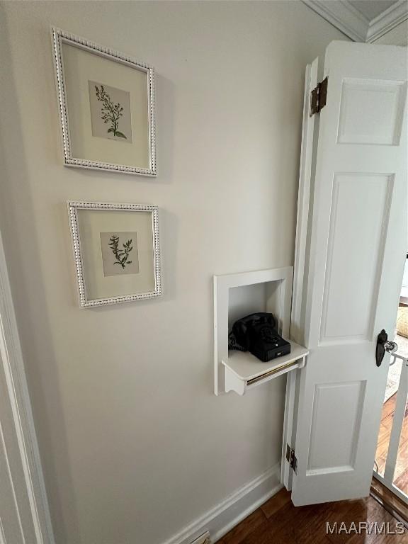 interior details featuring crown molding and hardwood / wood-style floors