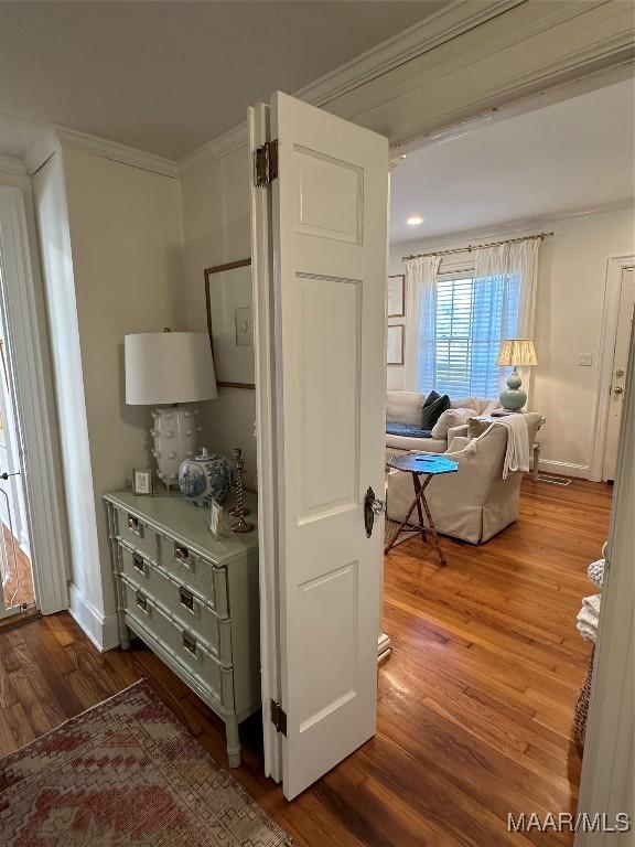 interior space with hardwood / wood-style floors and ornamental molding