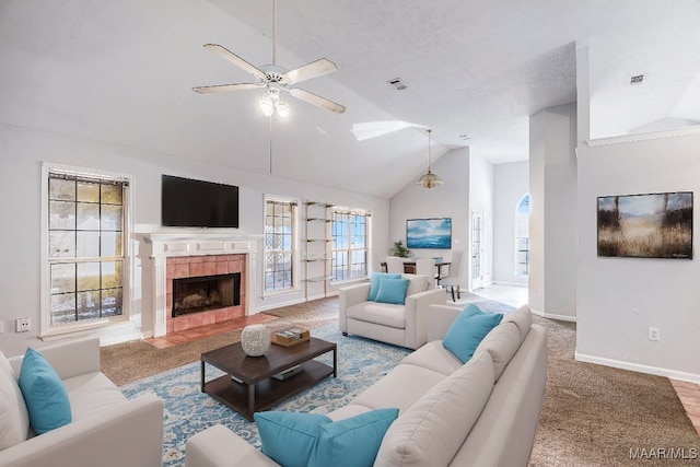 carpeted living room with a textured ceiling, a tiled fireplace, ceiling fan, and lofted ceiling