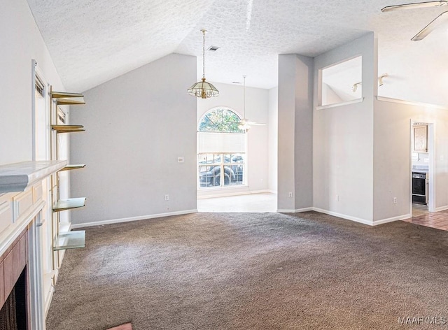 unfurnished living room with carpet, a textured ceiling, vaulted ceiling, and ceiling fan