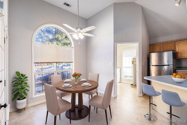 dining space featuring ceiling fan and high vaulted ceiling