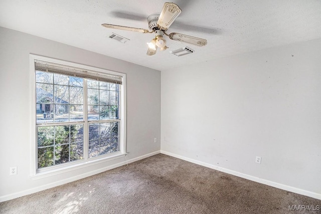 carpeted empty room featuring a textured ceiling and ceiling fan