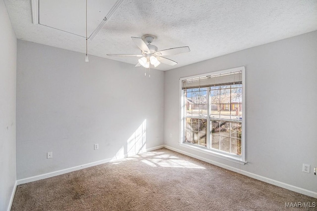 carpeted spare room featuring a textured ceiling and ceiling fan