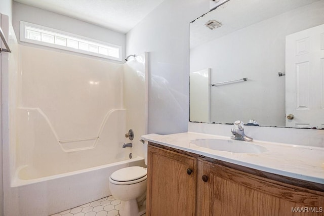 full bathroom with vanity, a textured ceiling, shower / bathing tub combination, tile patterned flooring, and toilet