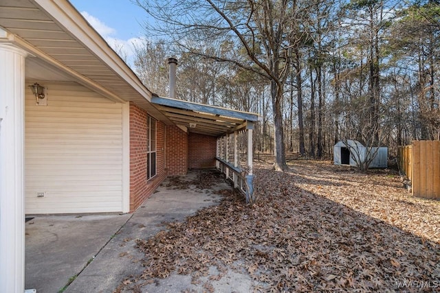 view of yard with a carport and a storage unit