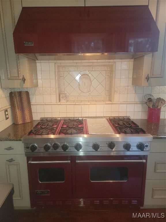 835 Park Ave, Montgomery, AL 36106 - kitchen with double oven range, backsplash, exhaust hood, and dark stone counters