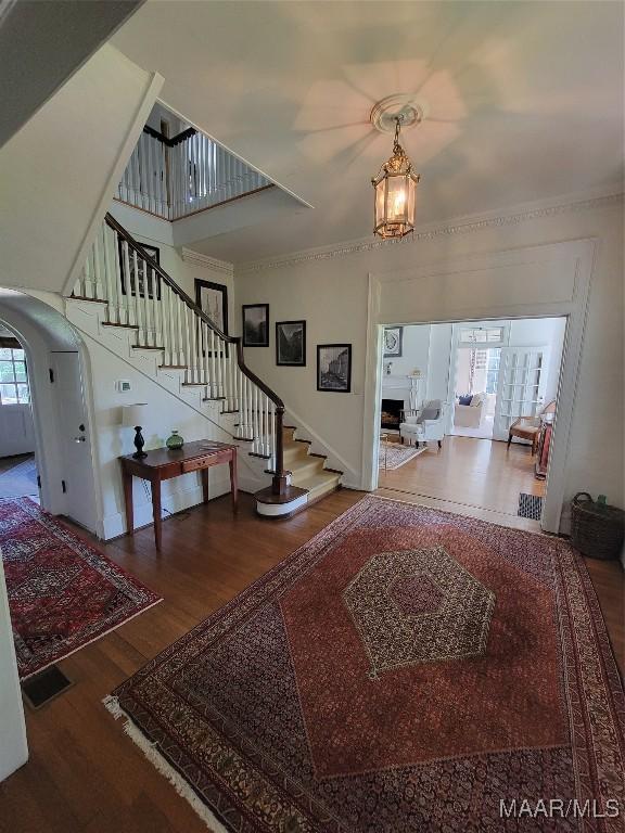 835 Park Ave, Montgomery, AL 36106 - entrance foyer featuring crown molding, hardwood / wood-style floors, and an inviting chandelier