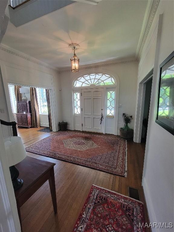 835 Park Ave, Montgomery, AL 36106 - entrance foyer featuring crown molding, an inviting chandelier, and hardwood / wood-style flooring